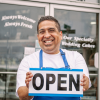 Small Business Owner Holding an Open Sign